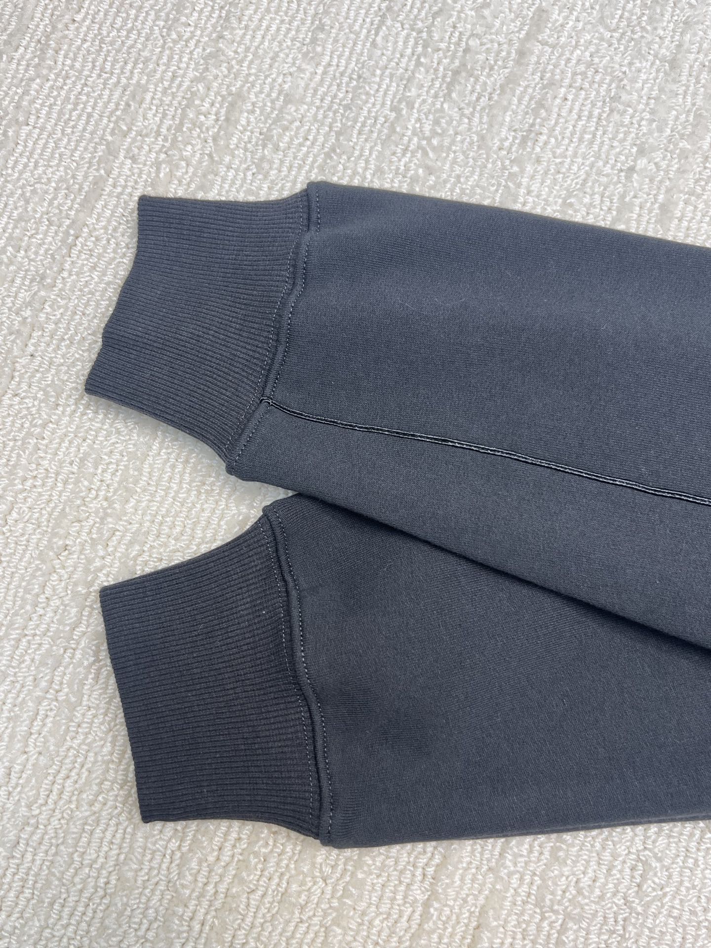 Dior hoodie sleeve cuffs and hem in dark navy knit fabric, folded view