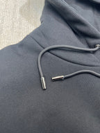 Dior hoodie drawstring and metal aglets on dark navy fabric close-up