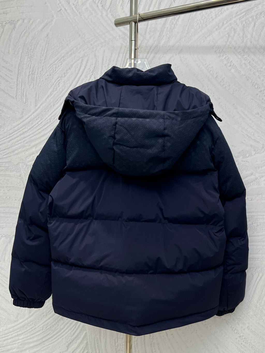 Navy hooded puffer jacket, padded shoulders and full zip closure, back view