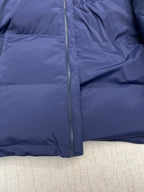 Blue puffer jacket front close-up of full zipper and padded quilting