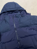 Blue hooded puffer jacket close-up of front zipper and textured quilted panels