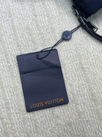 Navy puffer jacket with Louis Vuitton hang tag and drawstring