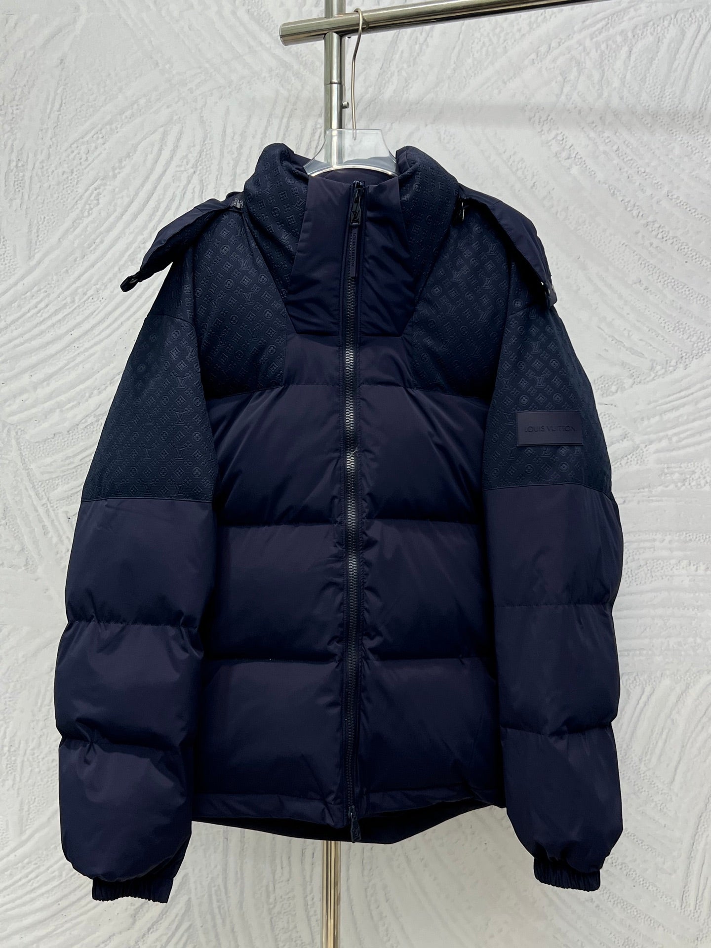 Navy hooded puffer jacket with full zip and quilted panels, long sleeves