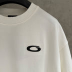 Balenciaga white T-shirt close-up of black G logo