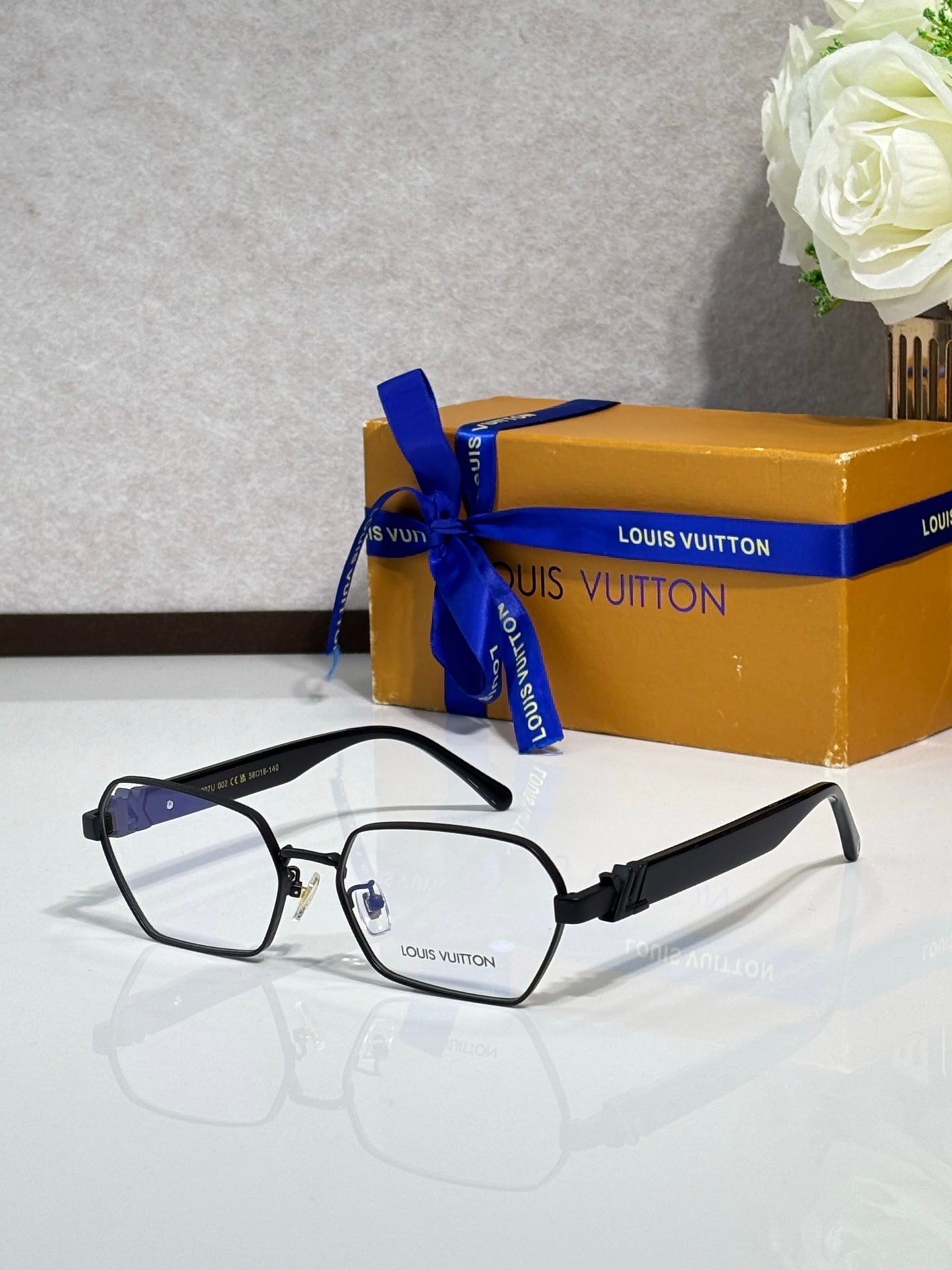 Black-rim square eyeglasses with clear lenses and dark logo temples