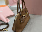 MiuMiu brown leather handbag, side view with zip pocket and short handles