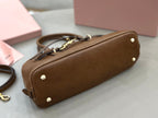 MiuMiu brown leather handbag with gold feet and top zipper edge