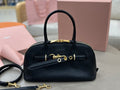 MiuMiu dark navy leather top-handle bag with gold-tone hardware and front buckle strap