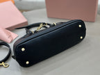 MiuMiu dark navy leather handbag bottom view with small round feet and gold-tone accents
