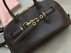 Dark leather top-handle bag with logo patch and gold-tone buckle hardware