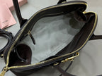 Dark leather zip-top bag open view with side pocket and top handles