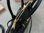 MiuMiu mini bag interior view, black with zipper pocket and gold-tone zipper