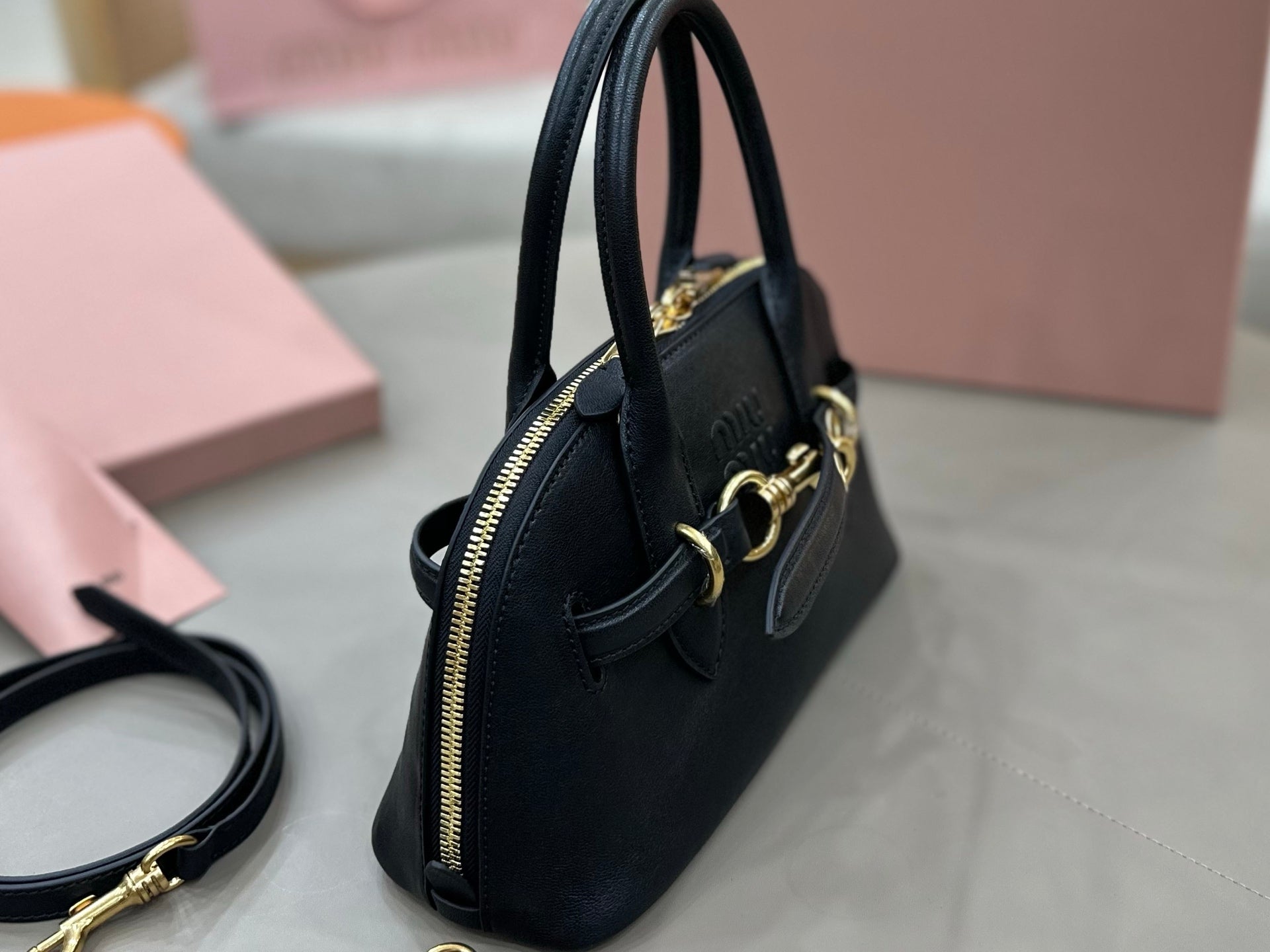 MiuMiu mini bag, black with side zipper pocket and gold hardware accents