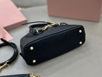 MiuMiu mini bag, black with gold feet, dual top handles, and short strap