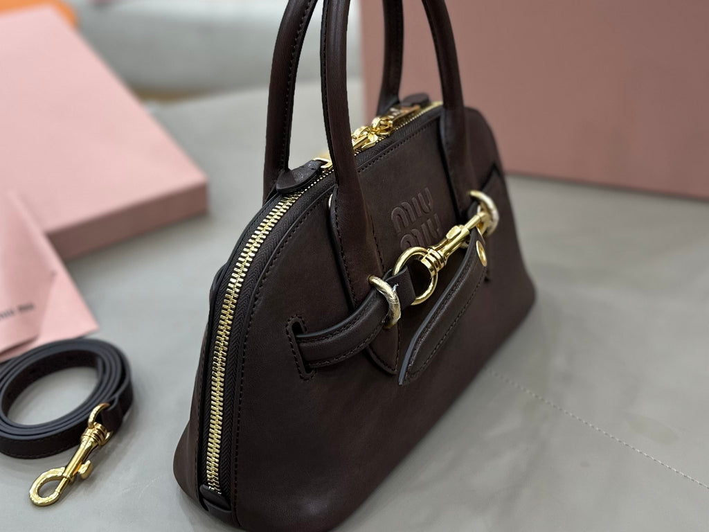 MiuMiu handbag side view with zip pocket and gold-tone hardware, dark brown