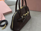 MiuMiu handbag side view with zip pocket and gold-tone hardware, dark brown