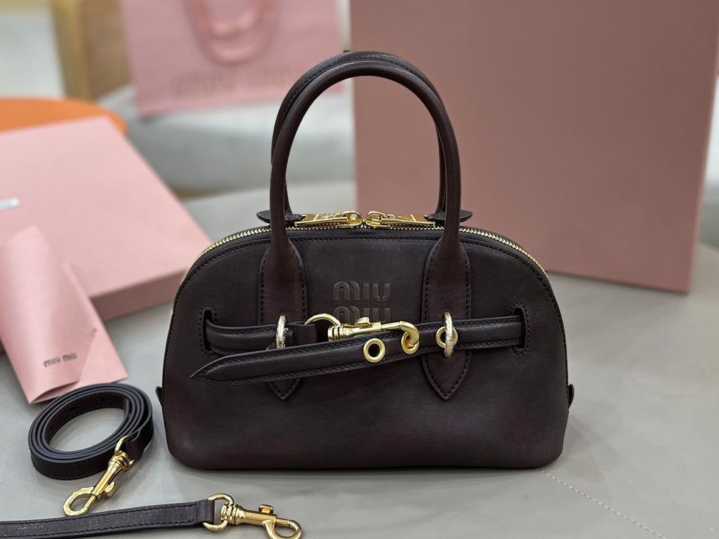 MiuMiu handbag with top handles, front flap, and gold-tone hardware, dark brown