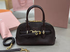 MiuMiu handbag with top handles, front flap, and gold-tone hardware, dark brown