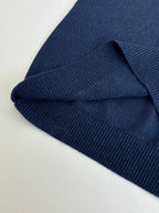 Folded navy sweater hem with ribbed knit cuff texture detail