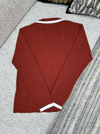 Red knit long-sleeve cardigan with white-trim cuffs, back view