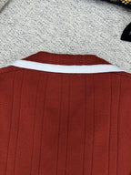 Red knit cardigan back with white-trim collar and vertical rib lines