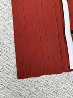 Red knit cardigan front panel with vertical ribbed texture
