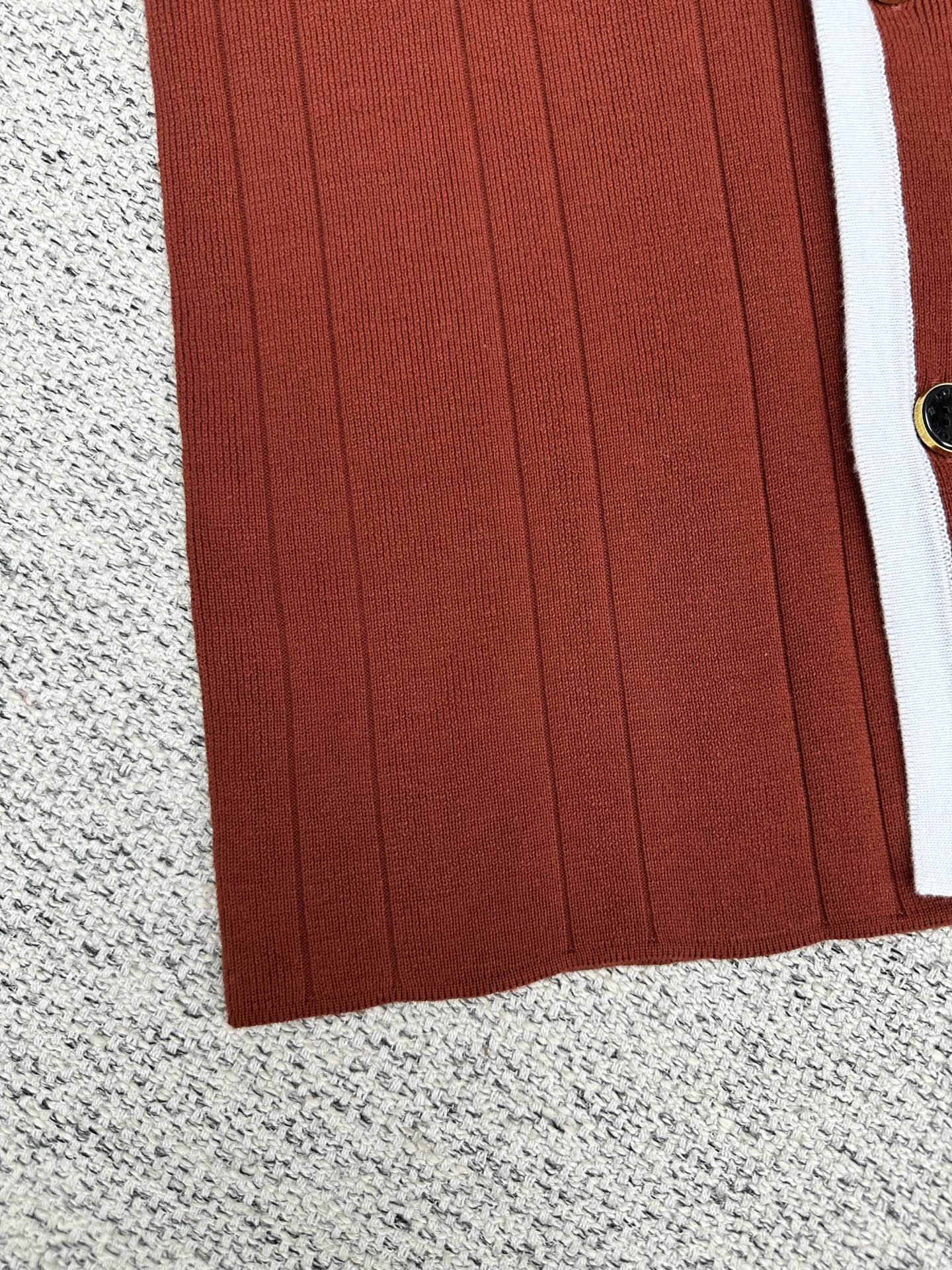 Red knit cardigan front panel with vertical ribbed texture