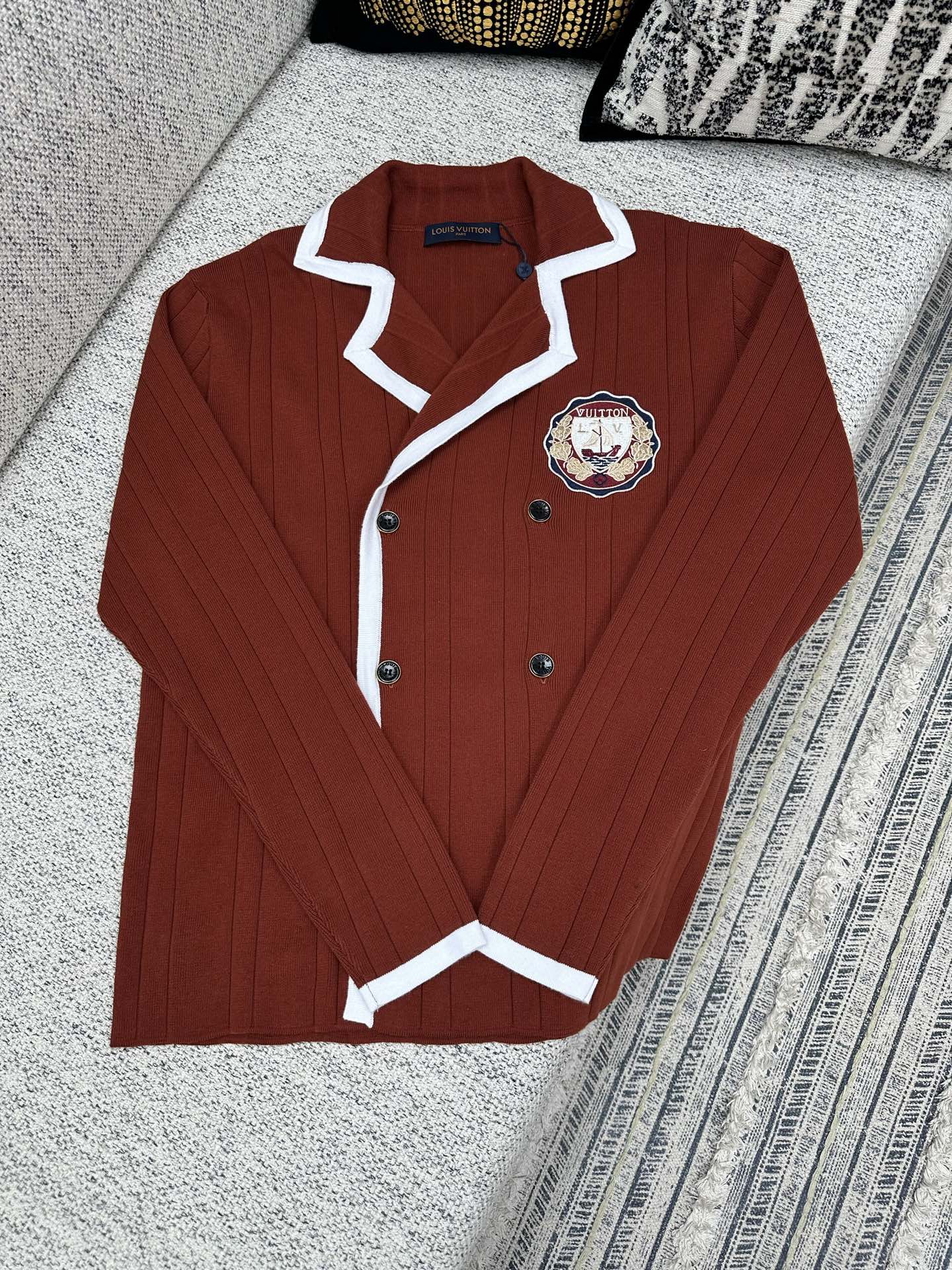 Red knit long-sleeve button cardigan with white trim and crest patch