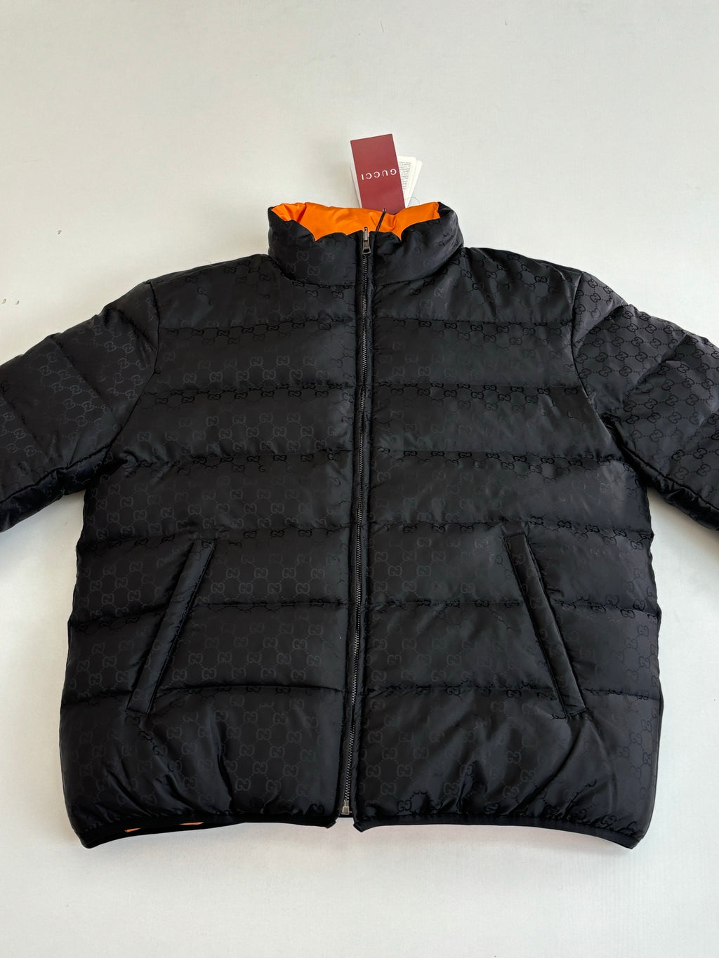 Gucci long puffer jacket in black, full-zip front with quilted paneling
