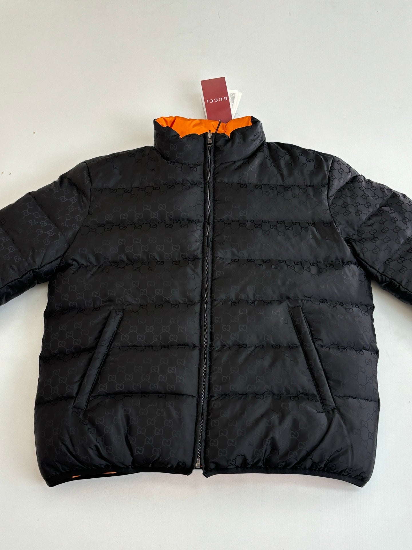 Gucci long puffer jacket in black, full-zip front with quilted paneling