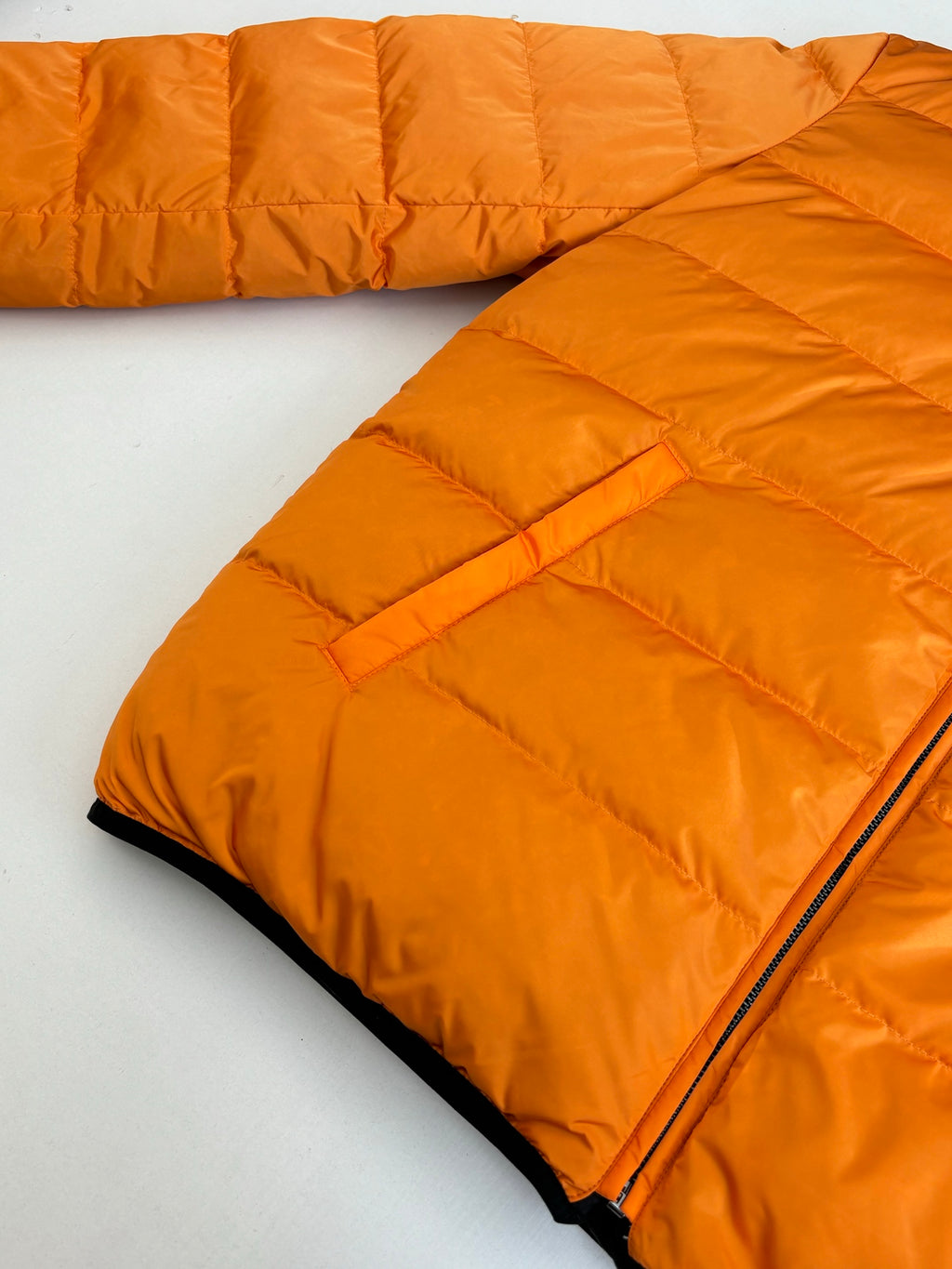 Gucci long puffer jacket in bright orange, fold-over panels and zipper edge