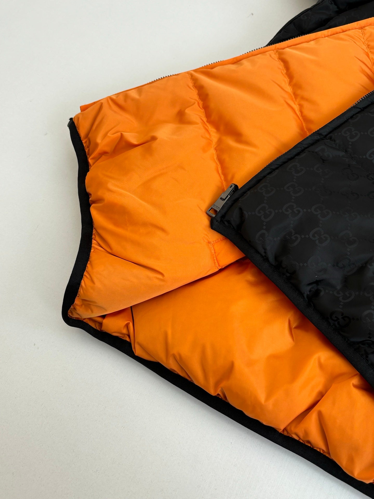 Gucci long padded jacket with orange lining and black trim, zip edge detail