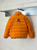 Gucci long puffer jacket in bright orange, back view with small logo tag