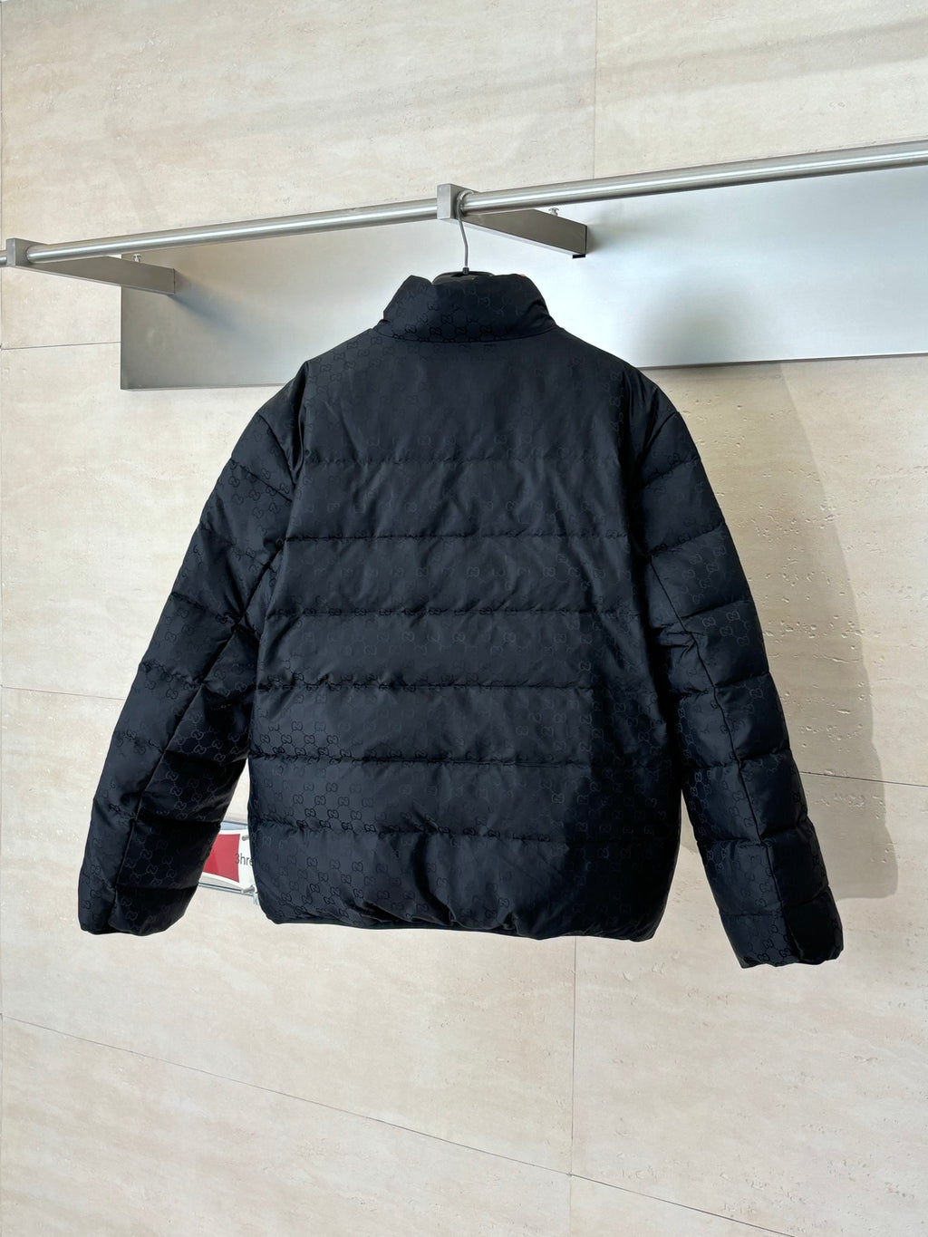 Gucci long puffer jacket in dark navy, back view with stand collar
