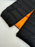 Gucci long puffer jacket in black with orange inner lining and visible zipper