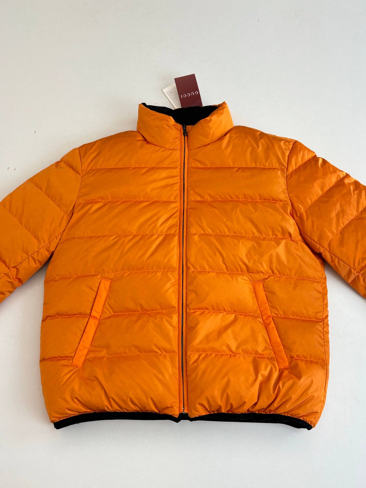Gucci long puffer jacket in bright orange, full-zip front with quilted panels