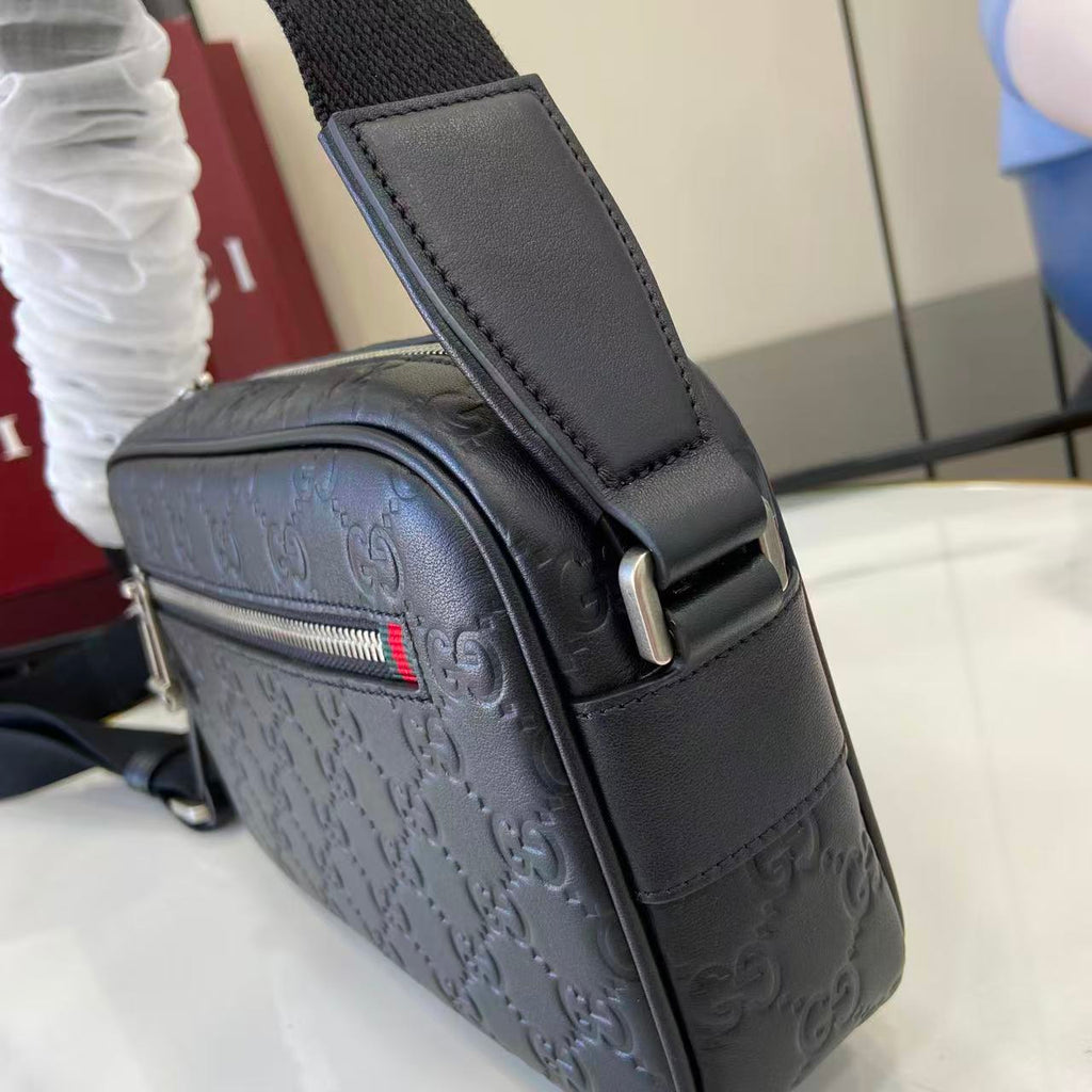 Gucci crossbody bag dark blue embossed GG with adjustable strap and metal buckle