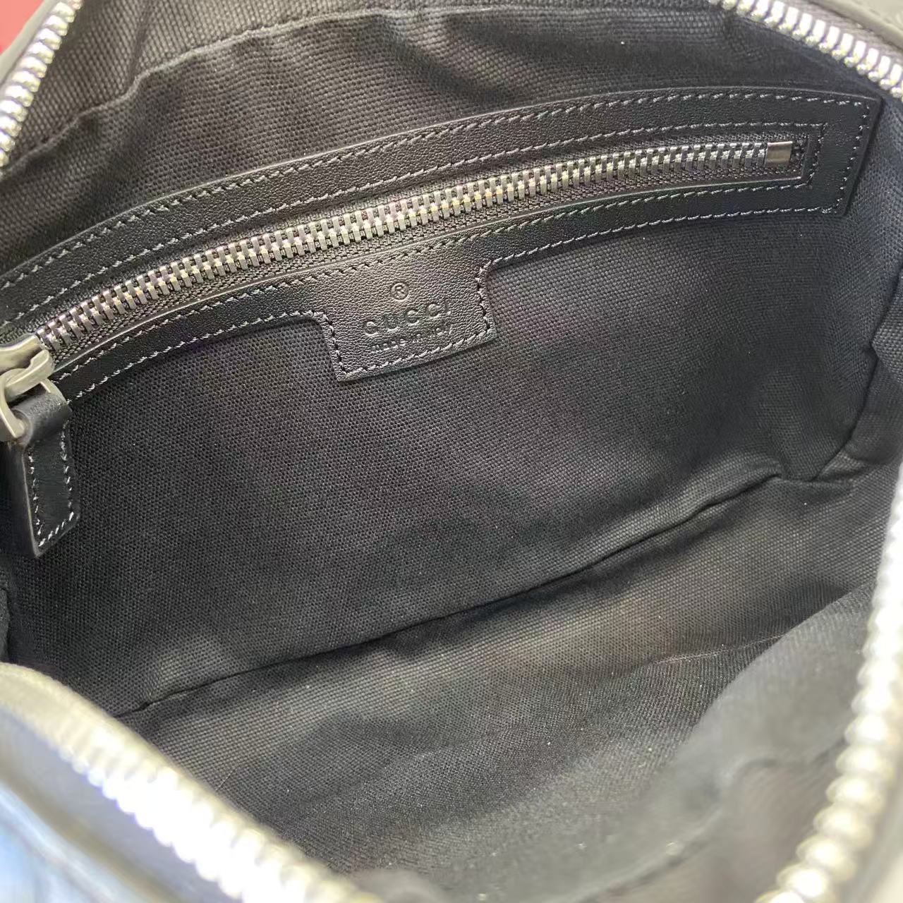 Gucci bag interior lining with leather tab and snap pocket