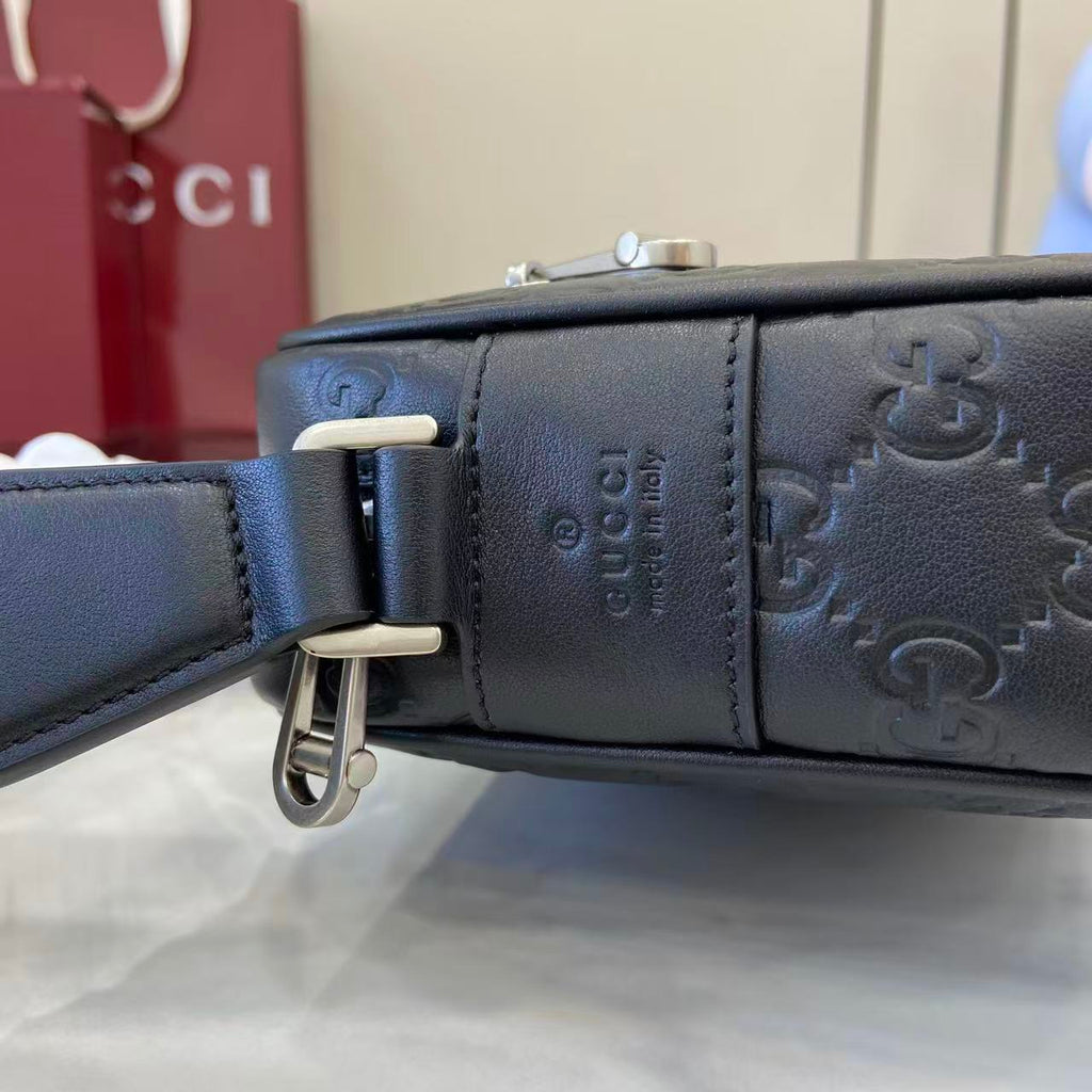 Gucci bag strap with dark leather texture and silver-tone buckle hardware