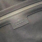 Gucci bag close-up of embossed leather label with stitching under the zipper