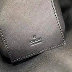 Gucci leather patch with 'GUCCI' logo, stitched edge on bag interior