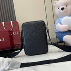 Gucci crossbody bag, embossed monogram, long strap extended across front