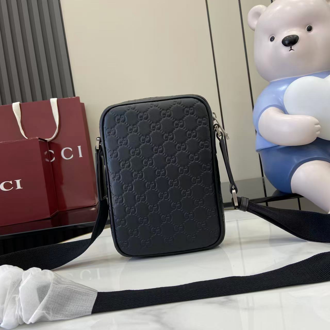 Gucci crossbody bag, embossed monogram, long strap extended across front