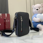 Gucci crossbody bag, embossed monogram texture, front zipper with striped pull