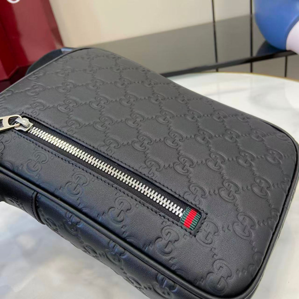 Gucci crossbody bag close-up, embossed monogram with metal zipper and striped pull