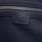 Dark navy interior pocket with Gucci GG embossed logo and zipper track