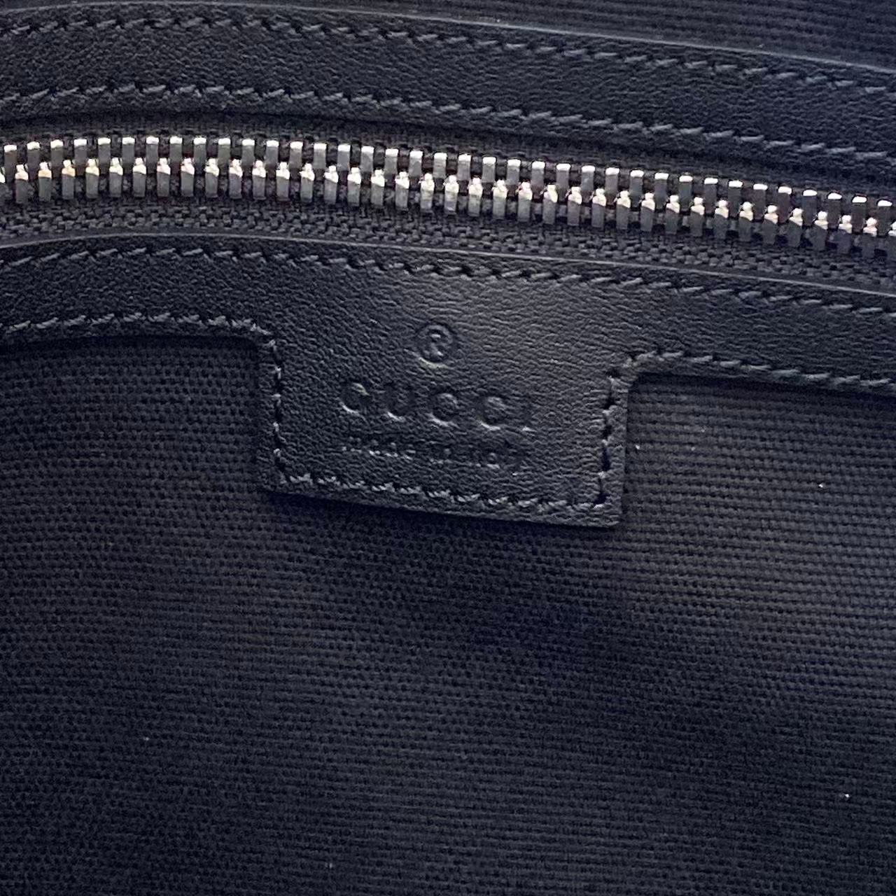 Dark navy interior pocket with Gucci GG embossed logo and zipper track