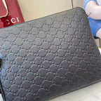 Dark navy monogram clutch bag with zip top and embossed GG pattern