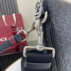 Dark navy crossbody strap detail with silver buckle hardware and green-red Web trim