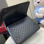 Blue embossed GG crossbody bag with metal eyelets and black lining visible